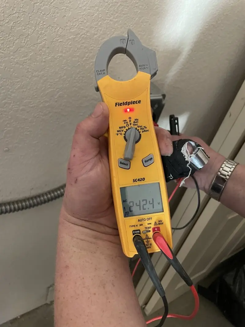 Voltage testing with clamp meter during Outlet Installation in Menands